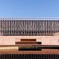 Modern Architectural Exterior Design With Glass Curtain Wall And People Walking Around