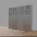 Modern Metal Bookcase With Glass Doors And Drawers Against White Wall Wooden Floor