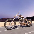 Vintage Motorcycle With Metallic Finish And Leather Seat On Open Road Against Mountain Sunset Sky