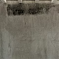 Concrete Sphere Component With Cracked Surface Against Textured Gray Wall With Black Stains