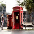 Charming Commercial Street Scene With Red Telephone Booth Postbox Bench Trees And Background Buildings