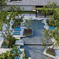 Serene Courtyard Garden With Lush Trees Water Feature Stone Pathway And Blue Seating