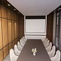 Modern Conference Room With Long Table White Chairs Projection Screen Wooden Walls And Ceiling Lights