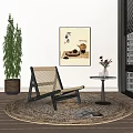 Woven Leisure Chair with Black Frame Round Rug Green Plant Wall Art and Side Table