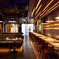 Modern Restaurant Interior With Wooden Partitions Pendant Lights Hanging Plants Round Dining Table And Chairs
