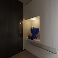Blue Cartoon Like Sculpture With Big Eyes In Niche By White Cabinet And Black Door