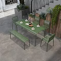 Commercial Outdoor Seating Space With Green Metal Table Chairs Bench And Plant Decorations