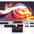 Modern TV Displaying Vibrant Natural Landscape With Game Controllers Keyboard And Printer