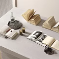 Open Books On White Table With Vintage Camera Glasses Bottle And Candles