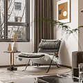 Soft Gray Accent Chair with Cushions by Window with Side Table Vase and Green Plant