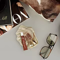 VOGUE Fashion Magazine And Hill Book With Beauty Products Sunglasses On Shell Shaped Tray