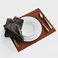 Elegant Dinnerware Set with White Plates Golden Cutlery and Dark Gray Napkin on Brown Placemat