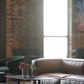 Industrial Style Restaurant Interior With Brick Walls Pendant Lights And Comfortable Seating
