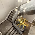 Modern Staircase Interior With Glass Railing Marble Floor Pendant Lights And Yellow Flowers