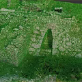 Ancient Stone Ruins Scenic Landscape Featuring Archway And Lush Green Grass