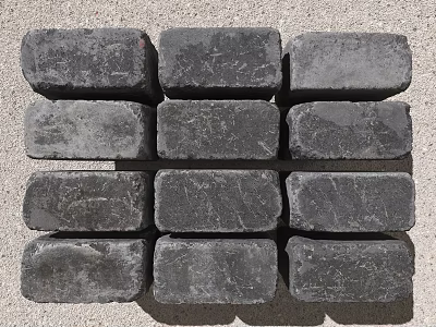 Black Textured Bricks Neatly Arranged In Rows For Paving Construction 3d model