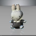 White Rabbit Toy With Gray Outfit And Bow Tie Sitting On Black Background