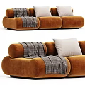 Brown Velvet Three-Seater Sofa With Gray Plaid Blanket And White Cushions