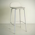 Two Modern Bar Stools With Wooden And Metal Frames Against Dark Wall And Light Floor
