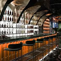 Modern Bar Interior With Bar Counter Wine Racks High Stools And Lighting Decor