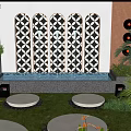 Modern Garden With Decorative Patterned Wall Water Feature Circular Seating And Green Plants