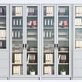 Modern Glass Door Bookcases With Binders Shelves Drawers And Small Plants