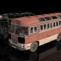 Old Red Vintage Bus and Burnt Black Damaged Bus on Reflective Surface