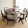 Modern Black Round Dining Table And Chair Set With Mesh Backs And Red Centerpiece