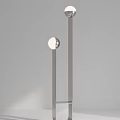 Modern Minimalist Floor Lamp With Sleek Metal Frame And Glass Base Against Neutral Wall