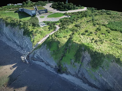 Scenic Coastal Cliff Landscape With Lush Green Vegetation Grassland Pathway And Buildings On Top 3d model