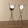 Two Modern Floor Lamps With Wooden Cross Legs And Round White Shades In Interior