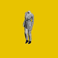 Mannequin wearing grey coat white pants black shoes on black base against dark background