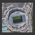 Aerial View Of Large Modern Football Stadium With Green Pitch And Surrounding Roads