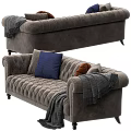 Elegant Dark Gray Tufted Sofa with Brown Blue Pillows and Gray Blanket