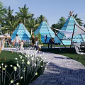 Camping Site With Green White Tents Palm Trees Lawn Decorative Lights Tables Chairs