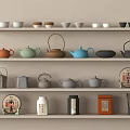 Display of Tea Set on Shelves with Various Colored Teapots Teacups Tea Cakes and Caddies