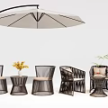 Modern Rattan Outdoor Chairs with White Umbrella Side Table Yellow Flowers and Green Plant