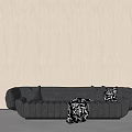 Baxter Black Sectional Sofa With Cushions And Throw Blanket Against Light Brown Wall