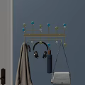 Modern Blue Wall Mounted Hook Organizer with Hanging Headphones Purse Towel and Colorful Beads