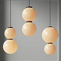 Three Modern Pendant Lights With Two Cream Colored Spherical Shades And Black Accents