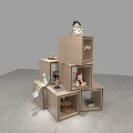 Floral Display With Stacked Wooden Cubes And Decorative Items Like Dolls Fruits And Books