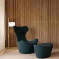 Teal Armchair With Ottoman Floor Lamp Light Colored Floor And Wooden Wall
