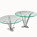 Two Circular Coffee Tables With Glass Top And Silver Feather Like Metal Base