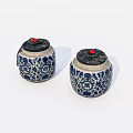 Traditional Ceramic Jars With Blue And White Floral Patterns And Red Top Accents