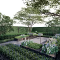 Courtyard Garden Design With Lush Trees Shrubs Hedges Stone Path And Flower Beds
