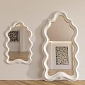 Modern Decorative Wall Mirrors With White Scalloped Frames Reflecting Artwork And Wooden Floor