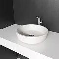 Modern White Washbasin On White Countertop Against Black Wall With Silver Faucet