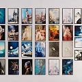 Multiple Framed Artworks in Various Styles Arranged on White Wall for Home Decor