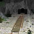 Railway Track Leading To Tunnel Entrance In Rocky Mountain Landscape With Trees
