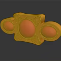 Golden Decorative Object Featuring Oval Shaped Red Gemstones and Ornate Patterns